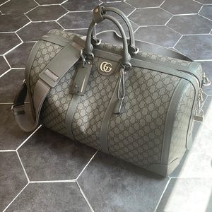 Selling brand new Gucci large duffle/travel bag. Used 1 time. Grey and black.